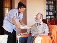 nurse delivering meal to patient