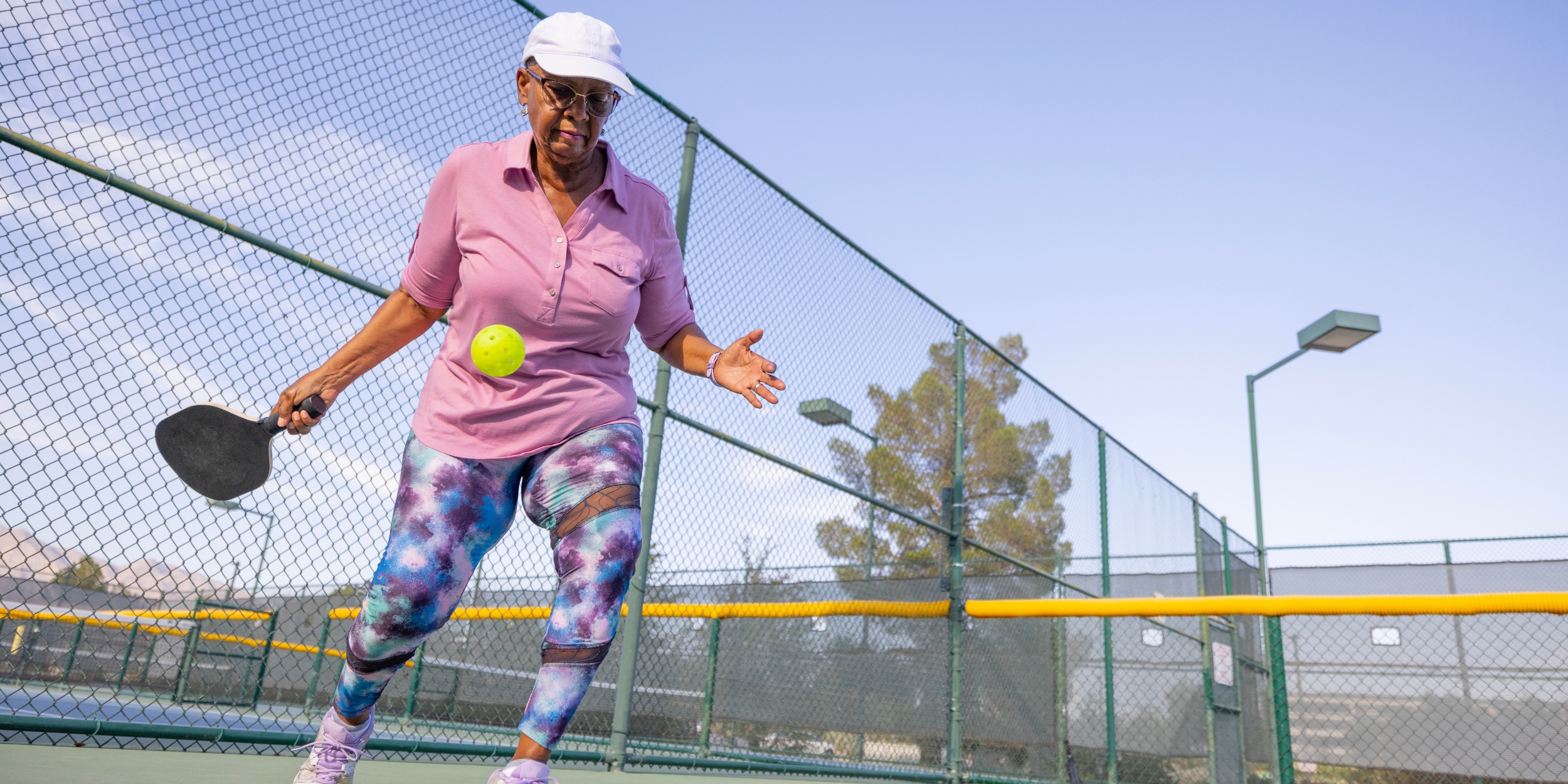senior woman playing pickleball