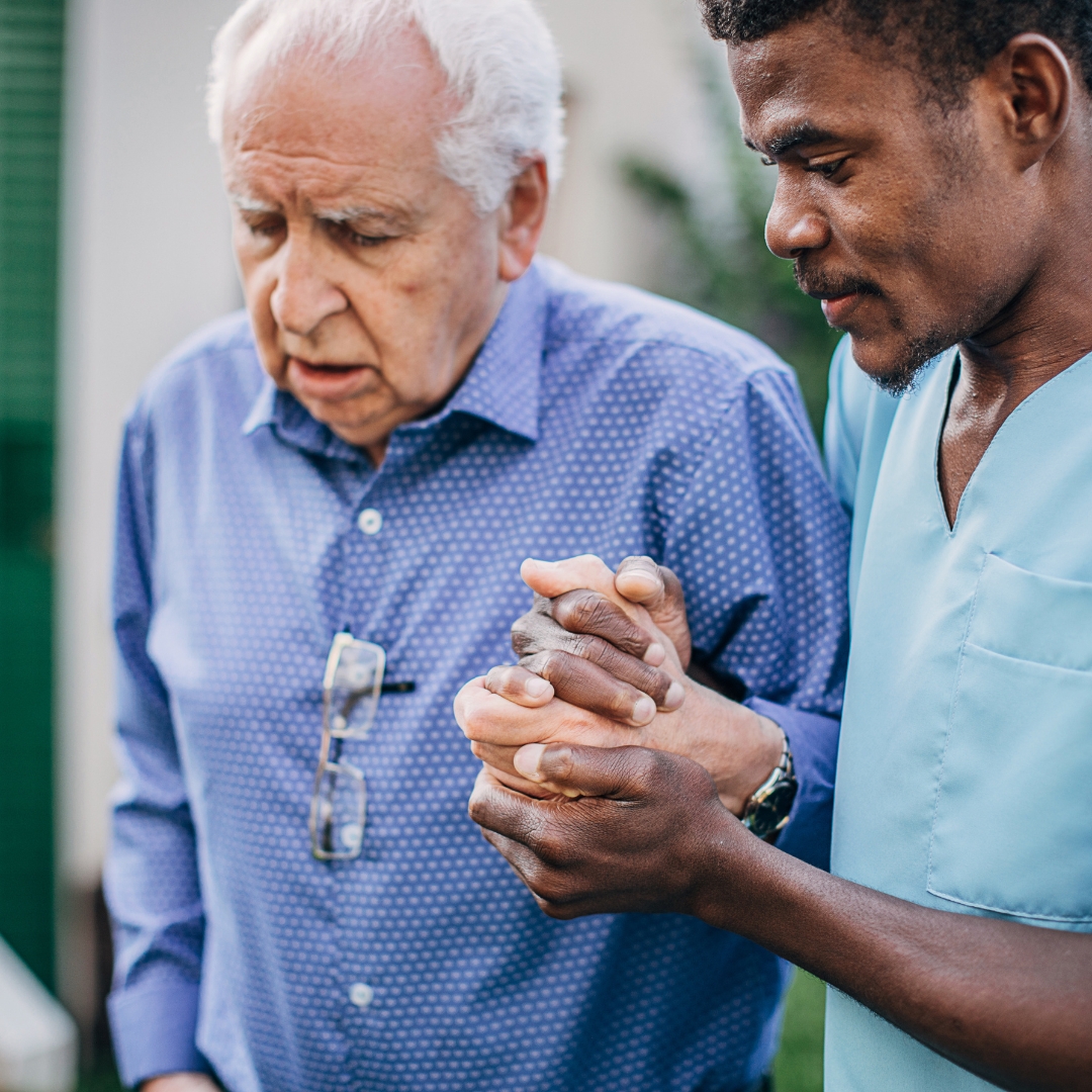 Man assisting a senior man walking